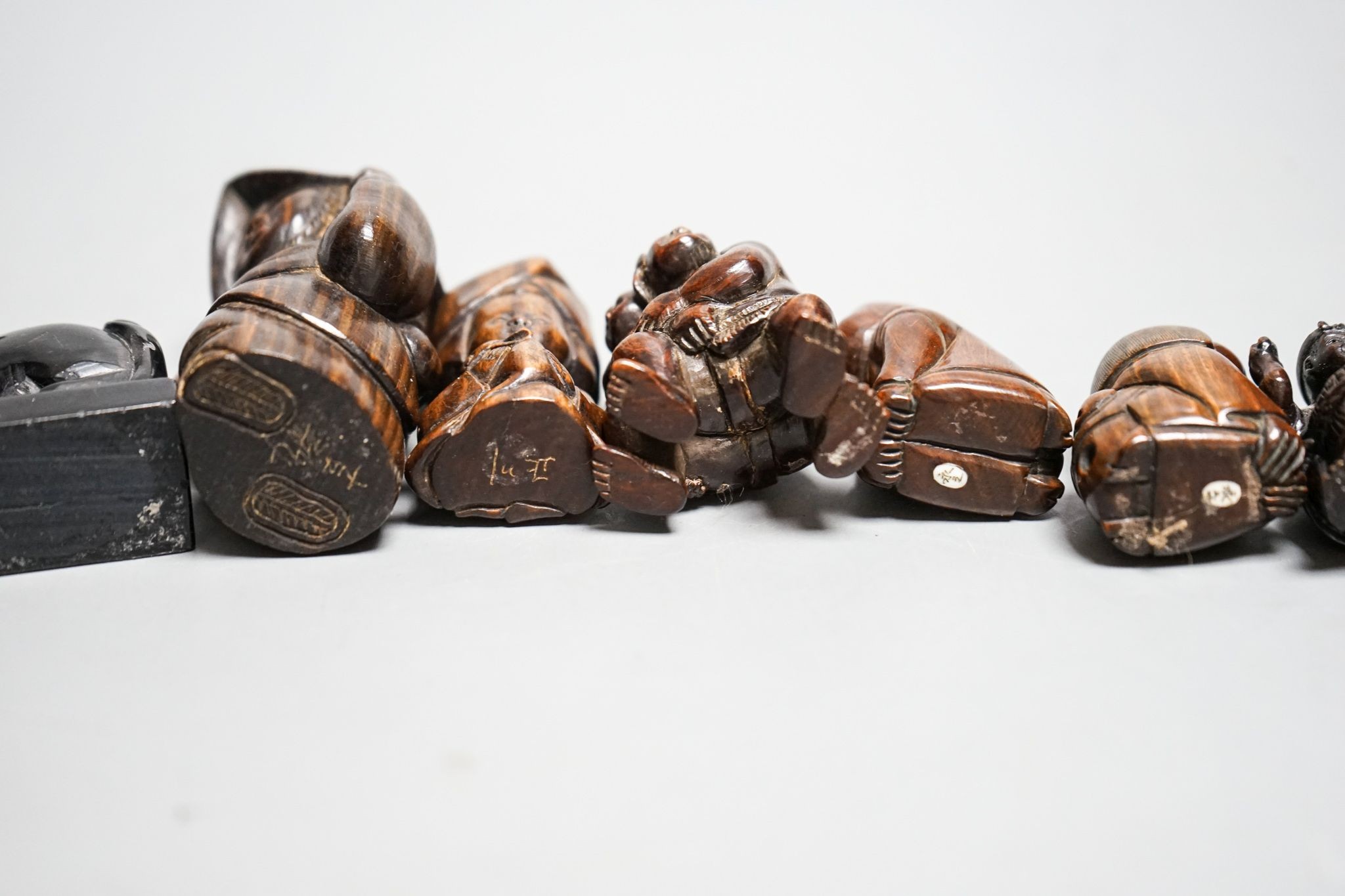 A quantity of hardwood netsuke and other carvings, signed